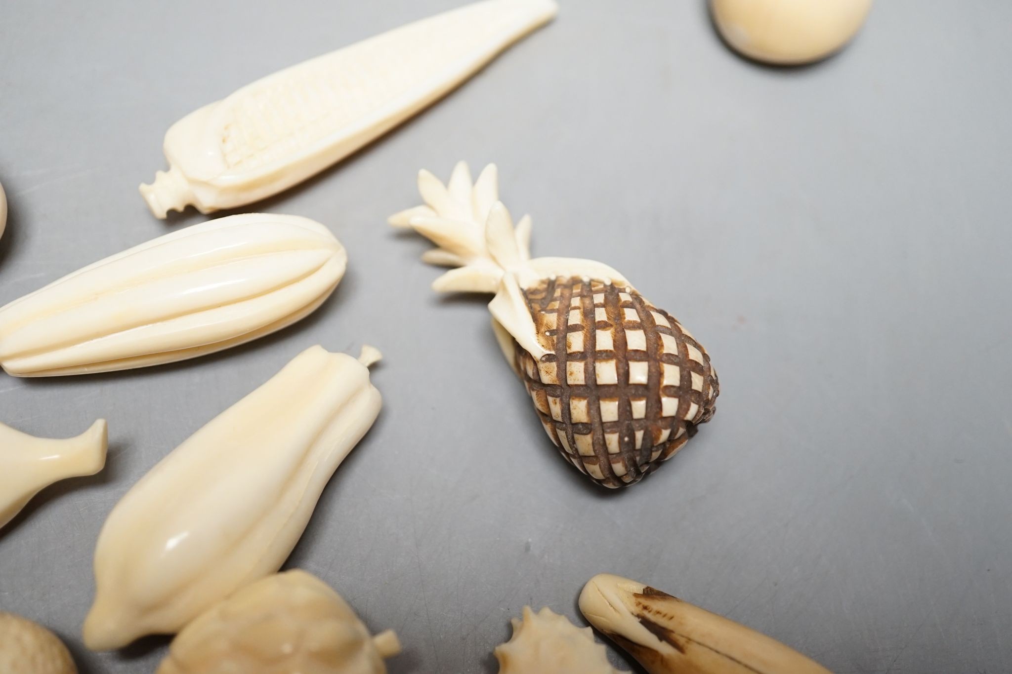 A group of Chinese carved ivory fruits, on ‘leaf’, 19cm